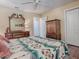 Bedroom with a large dresser and wood floors at 320 Rhapsody Path, The Villages, FL 32162