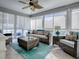 Relaxing sunroom with rattan furniture, a ceiling fan, and lots of natural light through the windows at 320 Rhapsody Path, The Villages, FL 32162