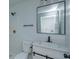 Modern bathroom with white vanity, black framed mirror, and updated fixtures at 324 N York St, Bushnell, FL 33513