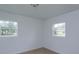 Bright bedroom featuring two windows and neutral colored walls at 324 N York St, Bushnell, FL 33513