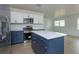 Open concept kitchen featuring blue and white cabinets and a large island at 324 N York St, Bushnell, FL 33513