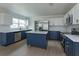 Modern kitchen with blue cabinetry, quartz countertops, and stainless steel appliances at 324 N York St, Bushnell, FL 33513