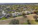 Aerial view of the property showcasing its roof, screened-in lanai, and neighboring houses at 3637 Hawkshead Dr, Clermont, FL 34711