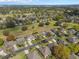 Aerial view of a home surrounded by lush greenery in a well-maintained community, outlined in yellow for emphasis at 3637 Hawkshead Dr, Clermont, FL 34711