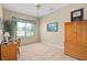 Cozy bedroom featuring a desk area and ample natural light from the window at 3637 Hawkshead Dr, Clermont, FL 34711