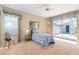 Cozy bedroom with neutral carpet, a ceiling fan, and sliding glass doors to the lanai at 3637 Hawkshead Dr, Clermont, FL 34711