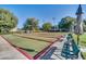 Outdoor community bocce ball court with benches surrounded by well maintained landscaping at 3637 Hawkshead Dr, Clermont, FL 34711