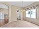 Cozy carpeted dining room featuring a hanging chandelier and natural light at 3637 Hawkshead Dr, Clermont, FL 34711