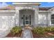 Inviting front entrance with decorative sidelights, an arched portico, and manicured landscaping for curb appeal at 3637 Hawkshead Dr, Clermont, FL 34711