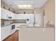 Well-lit kitchen with white appliances, granite countertops, and ample cabinet space at 3637 Hawkshead Dr, Clermont, FL 34711