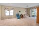 Inviting living room with a large window, comfortable seating, and soft carpet at 3637 Hawkshead Dr, Clermont, FL 34711