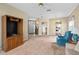 Spacious carpeted living room with ceiling fan, front door view, and furniture at 3637 Hawkshead Dr, Clermont, FL 34711