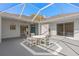 Screened patio with outdoor dining set and view of the home's architecture at 3637 Hawkshead Dr, Clermont, FL 34711