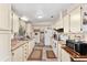 Galley-style kitchen with white cabinets at 37610 Quail Ridge Cir, Leesburg, FL 34788