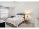 Main bedroom with plush bed and nightstand at 3818 Zentko St, The Villages, FL 32163