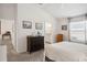 Main bedroom with dresser and access to en-suite bathroom at 3818 Zentko St, The Villages, FL 32163