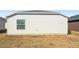 Exterior view of a house showcasing vinyl siding and a small yard at 3818 Zentko St, The Villages, FL 32163