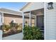 Exterior view of the home showing the screened porch and landscaping at 3818 Zentko St, The Villages, FL 32163