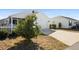 Front view of house with white garage door and picket fence at 3818 Zentko St, The Villages, FL 32163