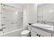 A bathroom with a white toilet, sink, and shower/bath is designed with a white theme at 3822 Miragalia Ln, The Villages, FL 32163