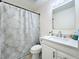 Updated bathroom with a white vanity and a gray shower curtain at 40 Moree Loop # 1, Winter Springs, FL 32708