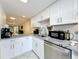 Updated kitchen features granite countertops and stainless steel appliances at 40 Moree Loop # 1, Winter Springs, FL 32708