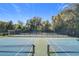 Well-maintained tennis courts with surrounding trees at 40 Moree Loop # 1, Winter Springs, FL 32708