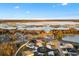 Expansive aerial view of a waterfront community with lush landscaping and beautiful homes by a serene lake at 4515 Biggs Pl, The Villages, FL 32163