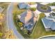 Aerial view of a well-manicured property with lush landscaping and a screened-in pool at 4515 Biggs Pl, The Villages, FL 32163