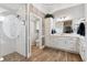 Well-lit bathroom with white cabinetry, walk-in shower, and wood look tile floors at 4515 Biggs Pl, The Villages, FL 32163