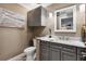 Bathroom featuring gray cabinets, a granite countertop, a toilet, and pendant lighting at 4515 Biggs Pl, The Villages, FL 32163