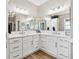 Bathroom featuring dual sinks with vanity, quartz countertops and custom mirrors at 4515 Biggs Pl, The Villages, FL 32163