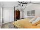 Bedroom features a four-poster bed, closet, painting, and wood look tile flooring at 4515 Biggs Pl, The Villages, FL 32163