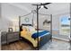 This bedroom has a four poster bed with yellow bedding and light gray walls at 4515 Biggs Pl, The Villages, FL 32163