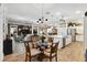 Dining area view into kitchen and open living space with built-in features and decor at 4515 Biggs Pl, The Villages, FL 32163