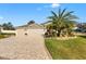 Charming home featuring a three-car garage, well-manicured landscaping, and decorative stone driveway at 4515 Biggs Pl, The Villages, FL 32163