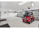 Large garage space with plenty of room for parking, storage, and a classic car at 4515 Biggs Pl, The Villages, FL 32163