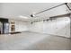 Spacious garage with multiple storage closets, stainless steel fridge, and epoxy-coated floor at 4515 Biggs Pl, The Villages, FL 32163