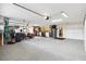 Spacious garage featuring epoxy floors, tool storage, and additional room for storage or a workshop at 4515 Biggs Pl, The Villages, FL 32163