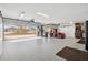 Spacious garage with epoxy flooring and a golf cart at 4515 Biggs Pl, The Villages, FL 32163