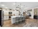 Modern kitchen featuring a center island with seating, white cabinetry, and stainless steel appliances at 4515 Biggs Pl, The Villages, FL 32163