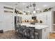 Bright and airy kitchen with a large island, stainless steel appliances, and stylish pendant lighting at 4515 Biggs Pl, The Villages, FL 32163