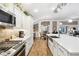 Modern kitchen with stainless steel appliances, a spacious island, and a view of the dining area at 4515 Biggs Pl, The Villages, FL 32163