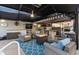 Covered outdoor patio area with a full kitchen, fire table, spa and comfortable seating at 4515 Biggs Pl, The Villages, FL 32163