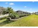 Well-maintained backyard landscaping surrounding a screened in pool area in a charming neighborhood at 4515 Biggs Pl, The Villages, FL 32163