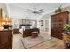 A well-lit main bedroom features a wooden bed and a large wardrobe at 4515 Biggs Pl, The Villages, FL 32163