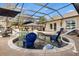 Inviting in-ground pool area with sun shelf, lounge chairs, and screened lanai for year-round enjoyment at 4515 Biggs Pl, The Villages, FL 32163