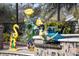 Close up of water feature at pool with decorative turtle and flamingos in pots and landscaping at 4515 Biggs Pl, The Villages, FL 32163