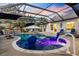 Inviting screened-in pool with elegant patio furniture, swim-up bar, and relaxing garden views, ideal for entertaining at 4515 Biggs Pl, The Villages, FL 32163