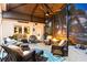 Inviting screened porch with comfortable seating, ceiling fan, and cozy fire pit at 4515 Biggs Pl, The Villages, FL 32163